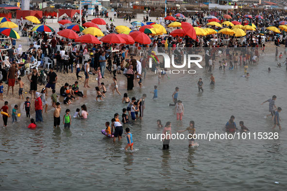 Palestinians enjoy the beach of the Mediterranean Sea on the coast of Gaza City, on June 2, 2023, during a heat wave. 