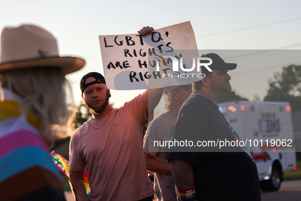 A pro-LGBTQ protestor holds a sign that reads, ''LGBTQ+ rights are human rights!'' Outside First Christian Church in Katy, Texas on June 3,...