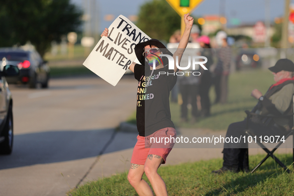 A pro-LGBTQ protestor holds a sign that reads, ''trans lives matter!'' Outside First Christian Church in Katy, Texas on June 3, 2023. 