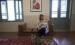 

An Iranian woman is sitting next to cats while visiting the ''Meowseum'' in downtown Teh...