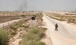 Palestinian Hamas security guards walk near an Egyptian watch tower on the border with Egy...