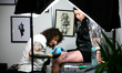 KRAKOW, POLAND - JUNE 11: A tattoo artist at work at the 16th Tattoofest Convention at EXP...