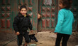 Palestinian children play in a poverty-stricken quarter on a rainy day of Beit Lahia town,...
