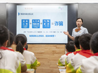 A staff member of China Construction Bank publicized fraud prevention knowledge to students on June 19, 2023 in Nantong, Jiangsu Province, C...