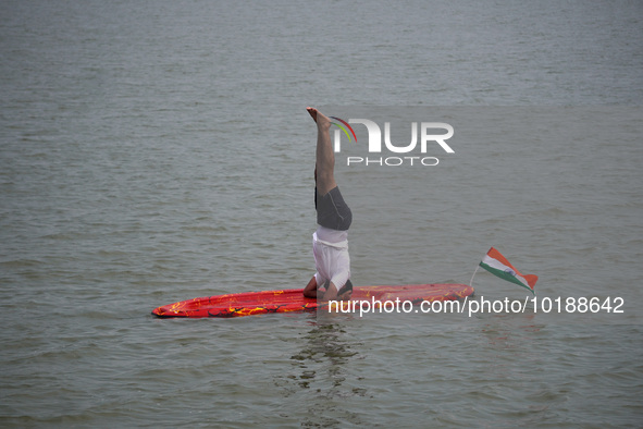 A participant performs yoga on the surface Yamuna River to mark the International Yoga Day celebrations on June 21, 2023 in New Delhi, India...
