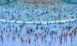 

Tourists are coming to the Water World to cool off during the hot weather in Nanjing, Ea...