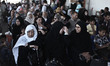 Palestinians wait under a hot sun to cross into Egypt at the Rafah crossing between Egypt...