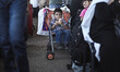 Gazan children rest next to their suitcases as they wait to cross into Egypt at Rafah cros...