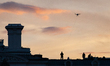 Secret Service agents work with a drone on top of the Executive Office Building while Pres...