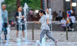 HEFEI, CHINA - JULY 7, 2023 - Children play with water to cool off at a fountain in a squa...