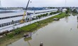 

Rescue workers are reinforcing electric poles by a river in Taizhou, Jiangsu province, C...