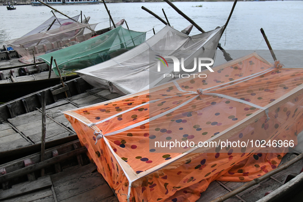 Boatmans sleep under a mosquito nets on their boats to protect them from dengue at the bank of the Buriganga River in Dhaka, Bangladesh, on...