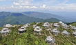 Workers work in high temperatures at the site of the Huilongshan Cliff homestay project in...