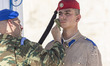 Heatwave in Greece. A soldier as seen wipe off the sweat from the face and cool off with w...