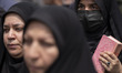 A veiled Iranian worshipper holds a copy of Muslims holy book of Koran during a protest ag...