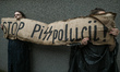 KRAKOW, POLAND - JULY 25, 2023:Activists hold a banner with words 'Stop PiS polution!' ou...