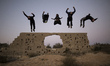 Palestinian youths from Gaza Parkour team, practice their Parkour skills in cemeteries in...