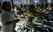 Thai and foreign Yoga enthusiasts perform yoga exercises during a Wine Yoga class  inside...