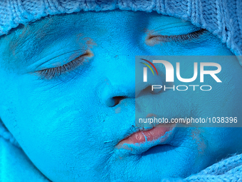 A baby with a blue painted face sleeps during a smurfs gathering in Waldshut-Tiengen, Germany on February 6, 2016. (