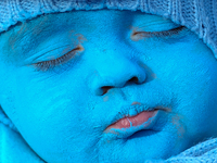 A baby with a blue painted face sleeps during a smurfs gathering in Waldshut-Tiengen, Germany on February 6, 2016. (