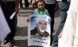 Palestinian Hamas supporters wave national flags while holding pictures of Sheik Raed Sala...