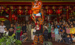 A lion dance attraction performs to closing the celebration in front of the Hook Tik Bio T...