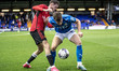 Ethan Pye #15 of Stockport County  tackled by the opponent during the EFL Trophy match bet...