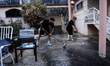 Residents of Mountain Parnitha, Greece, are trying to clean their yards of ash and coal on...
