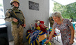 KHARKIV, UKRAINE - AUGUST 23, 2023 - A woman lays flowers at the memorial plaque unveiled...