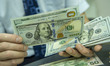 NANTONG,CHINA - SEPTEMBER 1, 2023 - A bank employee counts U.S. dollars in Nantong, Jiangs...
