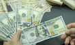 NANTONG,CHINA - SEPTEMBER 1, 2023 - A bank employee counts U.S. dollars in Nantong, Jiangs...
