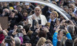 Pope Francis reacts as he arrives to hold his Weekly General Audience in St. Peter's Squar...