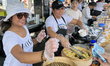 Women serve siomai (tasty dim sum dumplings) at a food stall during the Taste of Manila Fo...