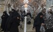 Shi'ite pilgrims at a holy shrine while taking part in a religious ceremony to commemorate...
