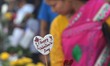 A Naga girl browses red rose in a street market in Dimapur ahead of Valentines Day in the...