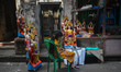 A little girl is selling Vishwakarma ( a craftsman deity and the divine architect of the d...