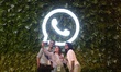 People click selfie picture in front of WhatsApp logo during an event in Mumbai, India, 20...