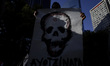 A person holds a banner in support of the mothers and fathers of the 43 missing normalista...