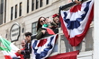 Italian-Americans wave flags of Italy while riding floats up 5th Avenue during the 79th Co...
