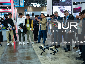 Visitors look at the four-legged walking robot of Rainbow Robotics, a South Korean company during the 2023 Robo World at the KINTEX exhibiti...