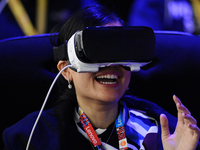 A woman reacts as she uses a new Samsung Gear 360 Vr , during the second day of Mobile World Congress 2016 in Barcelona, 23rd of February, 2...