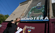 ZAPORIZHZHIA, UKRAINE - OCTOBER 23, 2023 - Project curator Liona Radchenko presents a mura...
