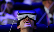 A congressman reacts as he uses a new Samsung Gear 360 Vr , during the 3rd day of Mobile W...