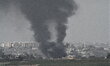 Smoke rises from buildings demolished by Israeli Air Force airstrikes and artilery are see...