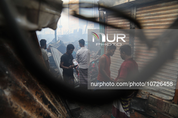 Traders are arriving to inspect their losses following a fire that broke out in Baburhat, Narsingdi, Bangladesh, on October 30, 2023. They a...