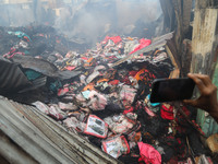 A burnt textile product is being examined in Baburhat, Narsingdi, Bangladesh, on October 30, 2023, following a fire. The location is current...