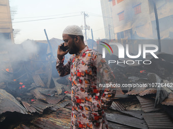 A trader is currently discussing the damaged textile products with his family after inspecting the fire damage in Baburhat, Narsingdi, Bangl...