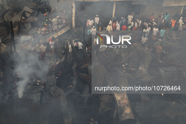 Traders are arriving to inspect their losses after a fire broke out in Baburhat, Narsingdi, Bangladesh, on October 30, 2023. The location is...