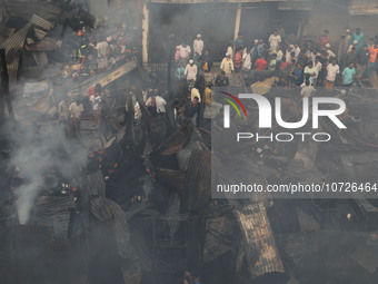 Traders are arriving to inspect their losses after a fire broke out in Baburhat, Narsingdi, Bangladesh, on October 30, 2023. The location is...