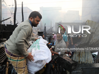 Traders are currently attempting to salvage some of the unburnt textile products from their shop following a fire in Baburhat, Narsingdi, Ba...